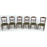 A set of six late Victorian mahogany dining chairs, with carved decoration, the seats upholstered in