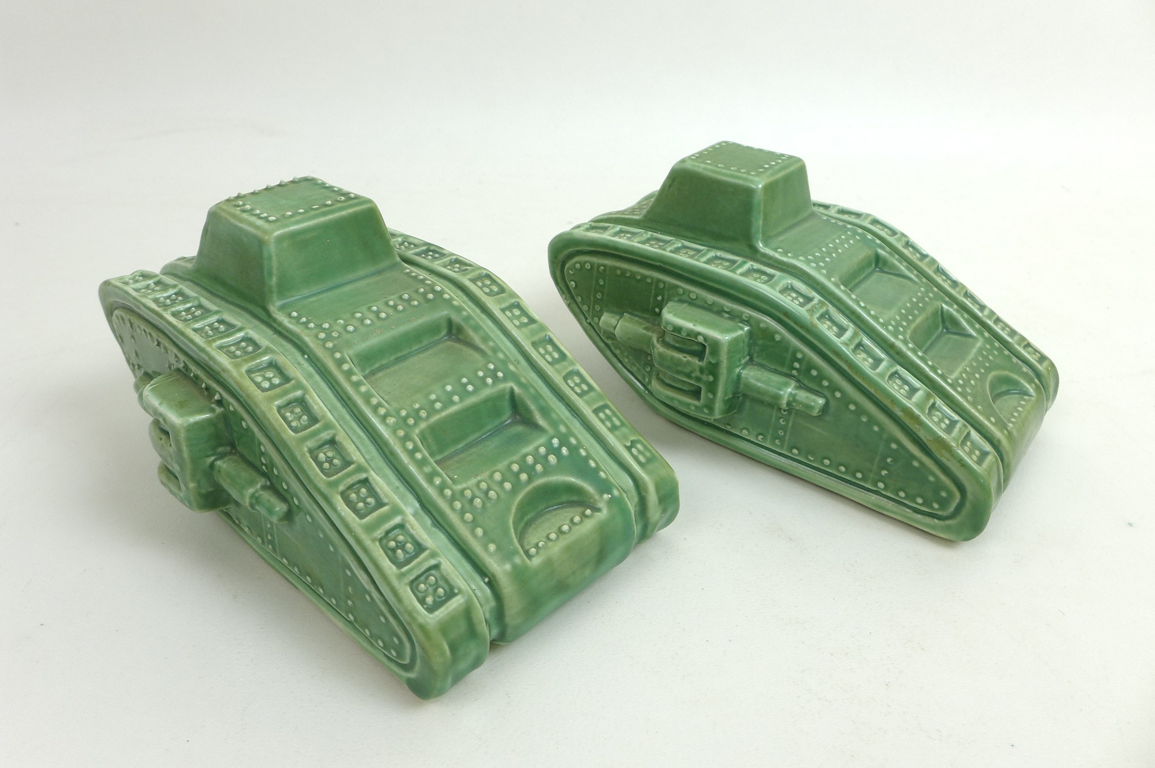 A pair of Carlton Ware WWI Mark IV style tanks, with green glaze, printed factory marks to bases,