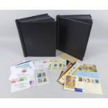 Two black albums containing a variety of mint unmounted British QEII stamps, each in outer boxes,