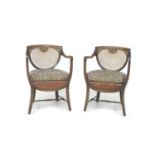 A pair of Edwardian oak open armchairs, with bergere seats and backs, each 56 by 56 by 80.5cm