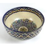 A large Iznik style polychrome tin glazed earthenware pottery bowl, likely 19th century, the cream