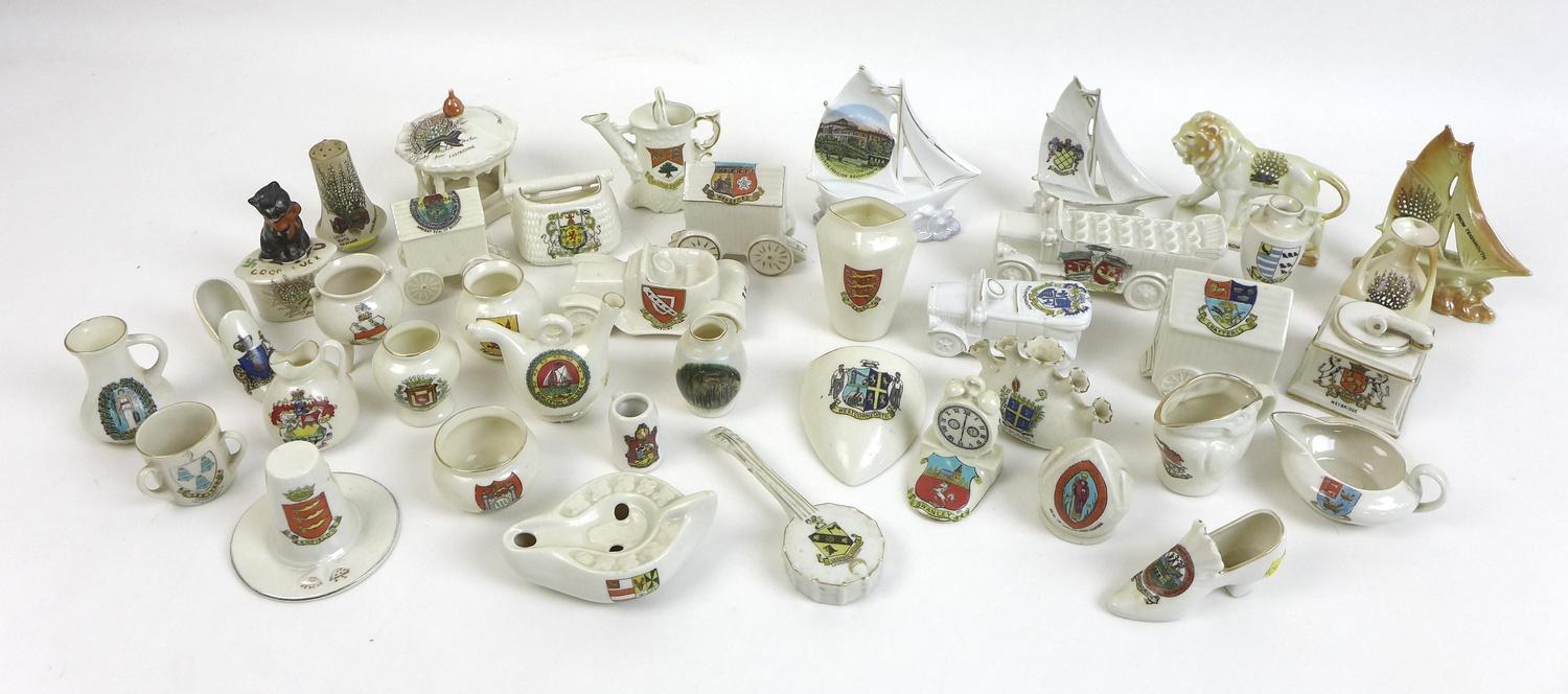 A large collection of crested china figurines, including W. H. Goss, Arcadian, Shelley and Carlton