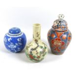 A group of Chinese ceramic vases, comprising a bottle vase, famille vert decorated with prunus