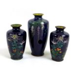 A group of three Meiji period finely decorated cloisonne posy vases, comprising a pair of vases