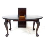 An early to mid 19th century mahogany extending dining table, the oval surface with moulded edge,