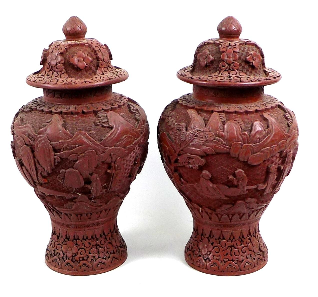 A pair of Chinese covered vases, likely red resin, early to mid 20th century, made to resemble