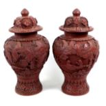 A pair of Chinese covered vases, likely red resin, early to mid 20th century, made to resemble