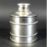 A George V silver dressing table bottle, of cylindrical form with banded body and lift off lid,