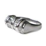 An Art Deco style platinum and diamond ring of unusual tapered barrel design, set with twelve