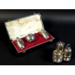 Two silver cruet sets, a Victorian silver set with pepper salt, mustard and pepper pot with