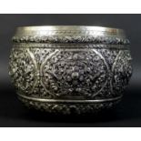 An early to mid 20th century Burmese silver bowl, intricately chased and repousse work depicting