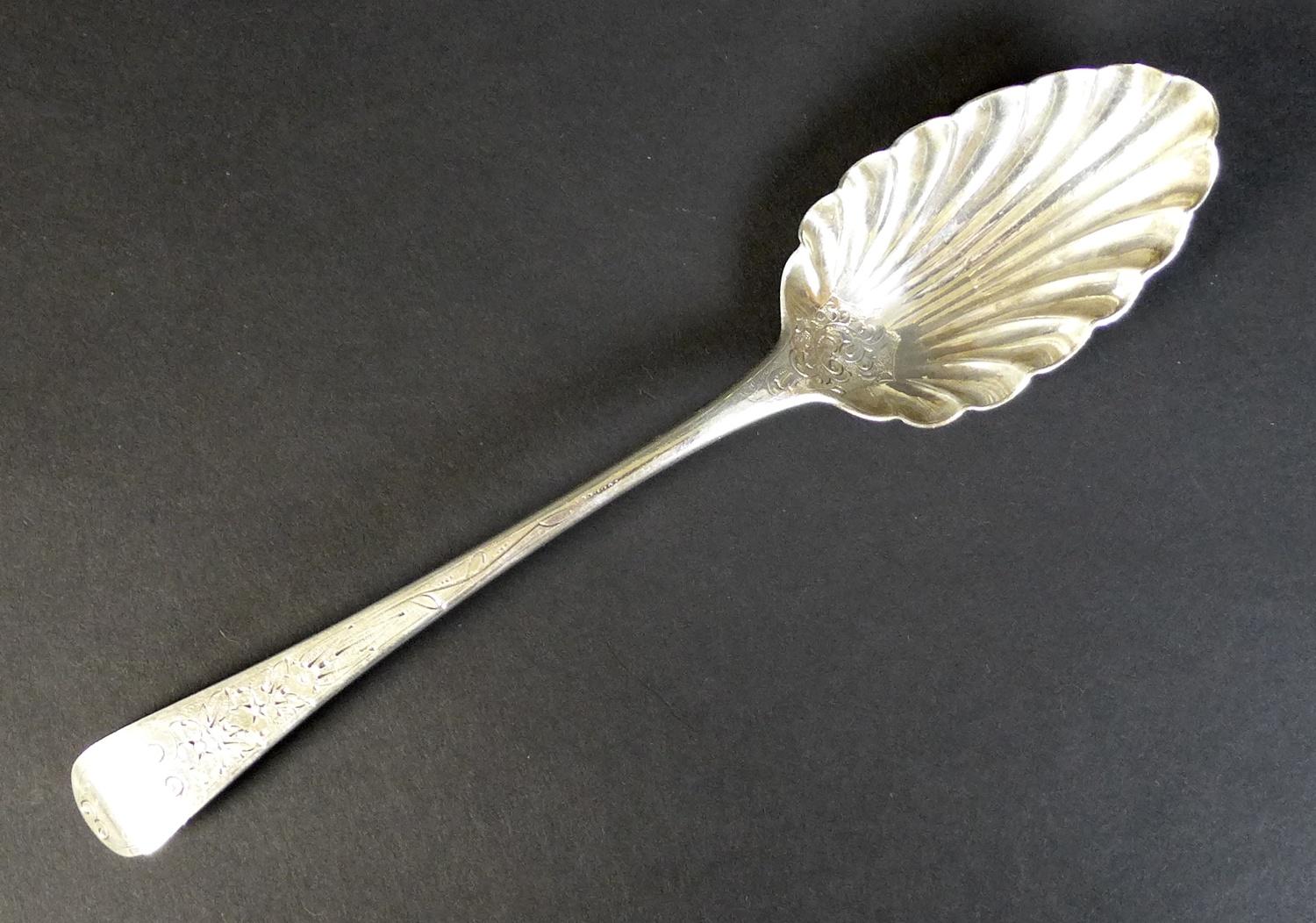 A George III silver serving spoon, with scalloped bowl and engraved decoration to handle,