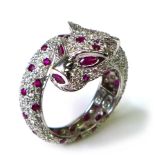 A 18ct white gold, diamond and ruby ring in the form of a coiled panther, by Brooks & Bentley,