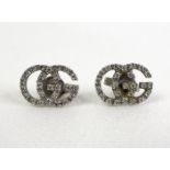 A pair of Gucci Italian 18ct white gold and diamond set earrings, in the form of the double G