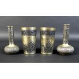A pair of Cambodian Khmer silver beakers and two bottle vases, all finely decorated with chased