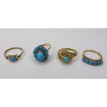 A group of four Middle Eastern gold rings, of varying designs but all set with turquoise, each