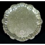 A George II silver waiter tray, of circular form with Chippendale pie crust edge, likely later