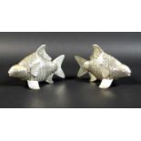 A pair of Cambodian Khmer silver articulated Siamese carp, with detailed bands of scales, and