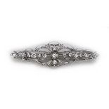 An Art Nouveau 18ct white gold and diamond bar brooch, with scrolled wire design set with twenty