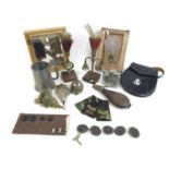 A group of military related items, including a Royal Inniskilling Fusiliers cap badge and feather,