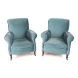 A pair of Edwardian wing armchairs, each upholstered in turquoise fabric, a/f in need of re-