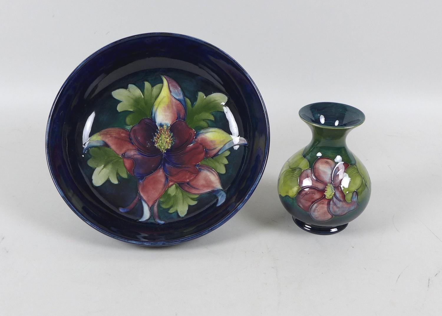 A Moorcroft bowl in the Hibiscus pattern, on a midnight blue ground, 25cm, together with a Moorcroft