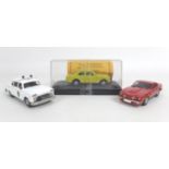 Three 1/43 scale die-cast models cars, a limited edition Ford Escort Mk.1 in yellow from Hedingham