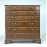 A George III oak chest of two short over five long graduating drawers, with brass swan neck handles,