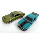 Two Boss die cast 1/43 scale model cars, a 1970 Ford Mustang in green, with detachable wing mirrors,