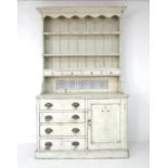 A Victorian painted pine Welsh dresser, the closed back with plate racks above with four inset spice