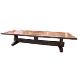 A very large modern office conference table, of oversized trestle form, tropical hardwood, the