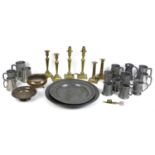 A collection of brass and pewter items, comprising two pewter dishes, 42cm and 35cm, a group of