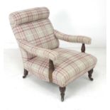 A late Victorian mahogany easy open armchair, with padded arms on ring turned supports and a bolster
