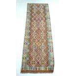 A vegetable dyed wool Chobi Kelim rug, with diamond patterned field and geometric borders in