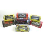A collection of seven die cast models of sports cars and racing cars, including six 1/24 scale cars,