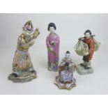 A group of four Oriental figurines, a Hochst style Chinese lady carrying her wares, with cartwheel
