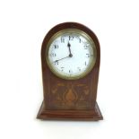 An Edwardian mahogany mantle clock, the domed topped case with decorative marquetry inlay, white
