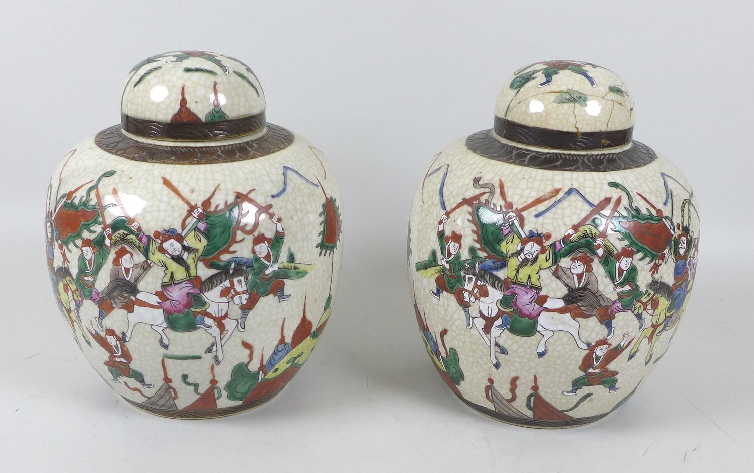 A pair of early 20th century Chinese porcelain ginger jars and covers, decorated as a mirrored pair,