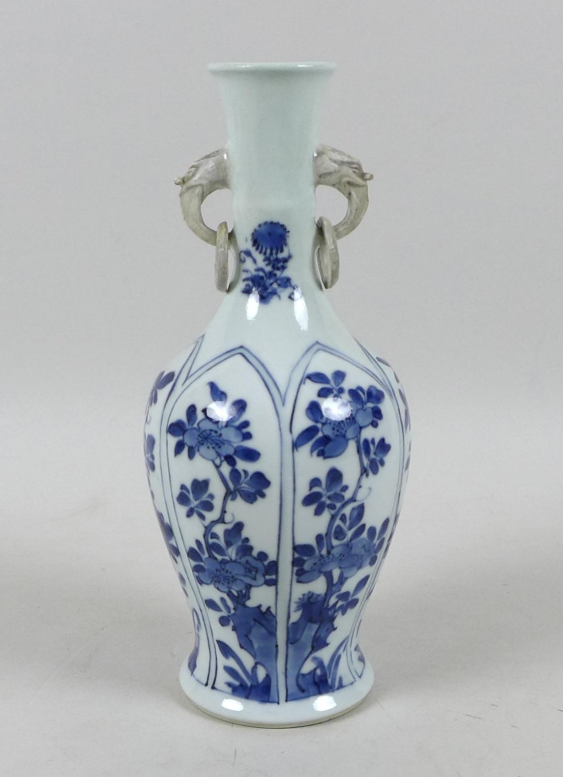 A Chinese porcelain vase, Qing Dynasty, 19th century, of long necked baluster form, with applied