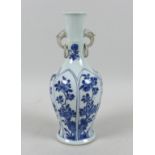 A Chinese porcelain vase, Qing Dynasty, 19th century, of long necked baluster form, with applied