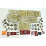 Over one hundred and fifty British army badges and Royal Navy buttons, with approximately forty