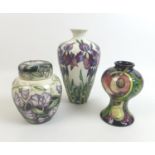 Three pieces of Moorcroft pottery, comprising a Queen's Choice slender baluster form vase, with