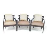 A set of three modern armchairs, by Baker, black geometric design frames, each with loose mushroom