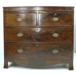 A Regency mahogany bow fronted chest of two short over two long drawers, with cock beading and