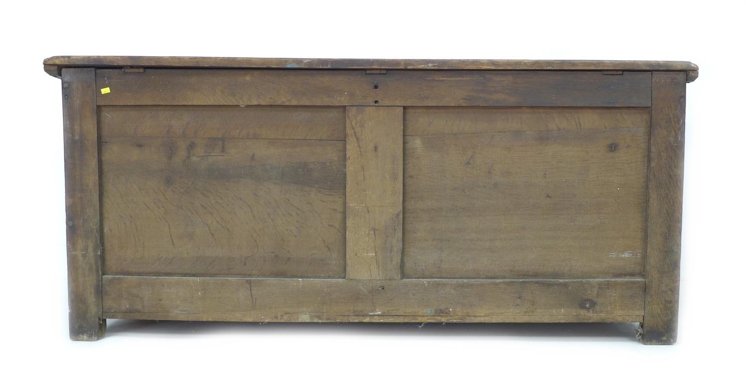 A large 18th century oak chest, two plank lift top, three panel front, stile feet, 155 by 63 by 67. - Image 7 of 8