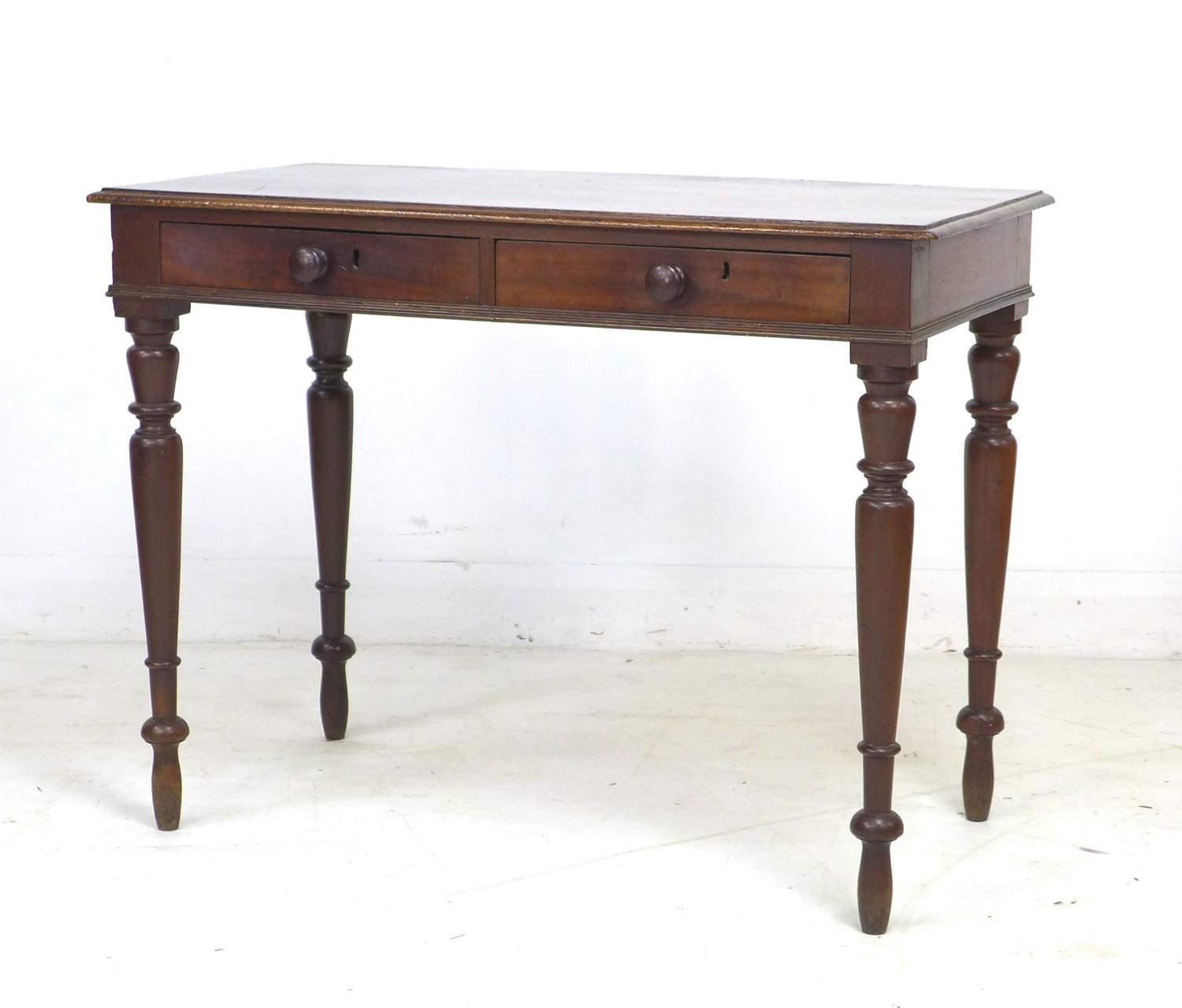 A mid Victorian mahogany side table, with moulded surface, two frieze drawers with turned handles,
