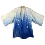 An early 20th century Japanese haori padded jacket, embroidered in silk with white and pink flowered