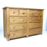 A modern pine chest of drawers, with an arrangement of four short over six long drawers with