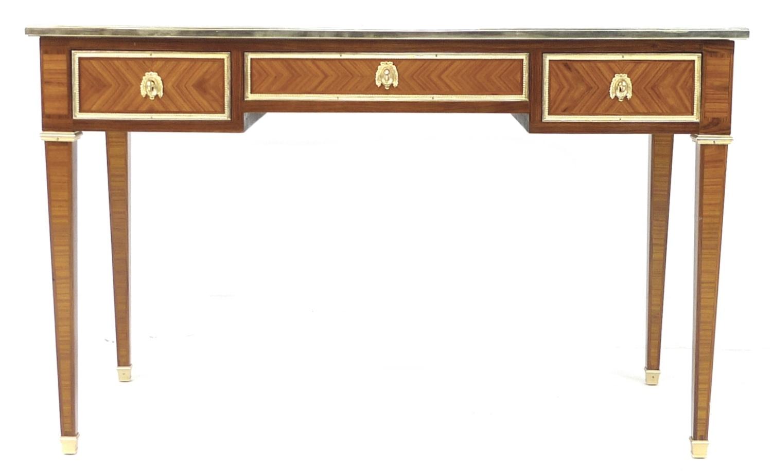 A modern French style bureau plat, the rectangular surface with quarter veneer and crossbanding,