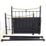 A Victorian brass and iron double bed frame, with brass ball finials and black painted spindle